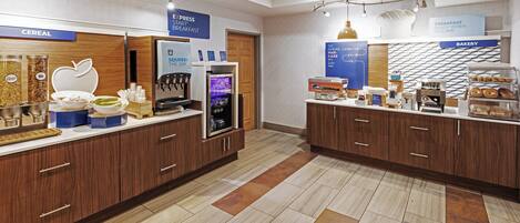 A breakfast area with cereal, a smoothie bar, and a bakery section.