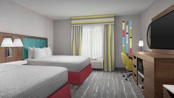 A hotel room with two beds, a desk, a TV, and a window with curtains.