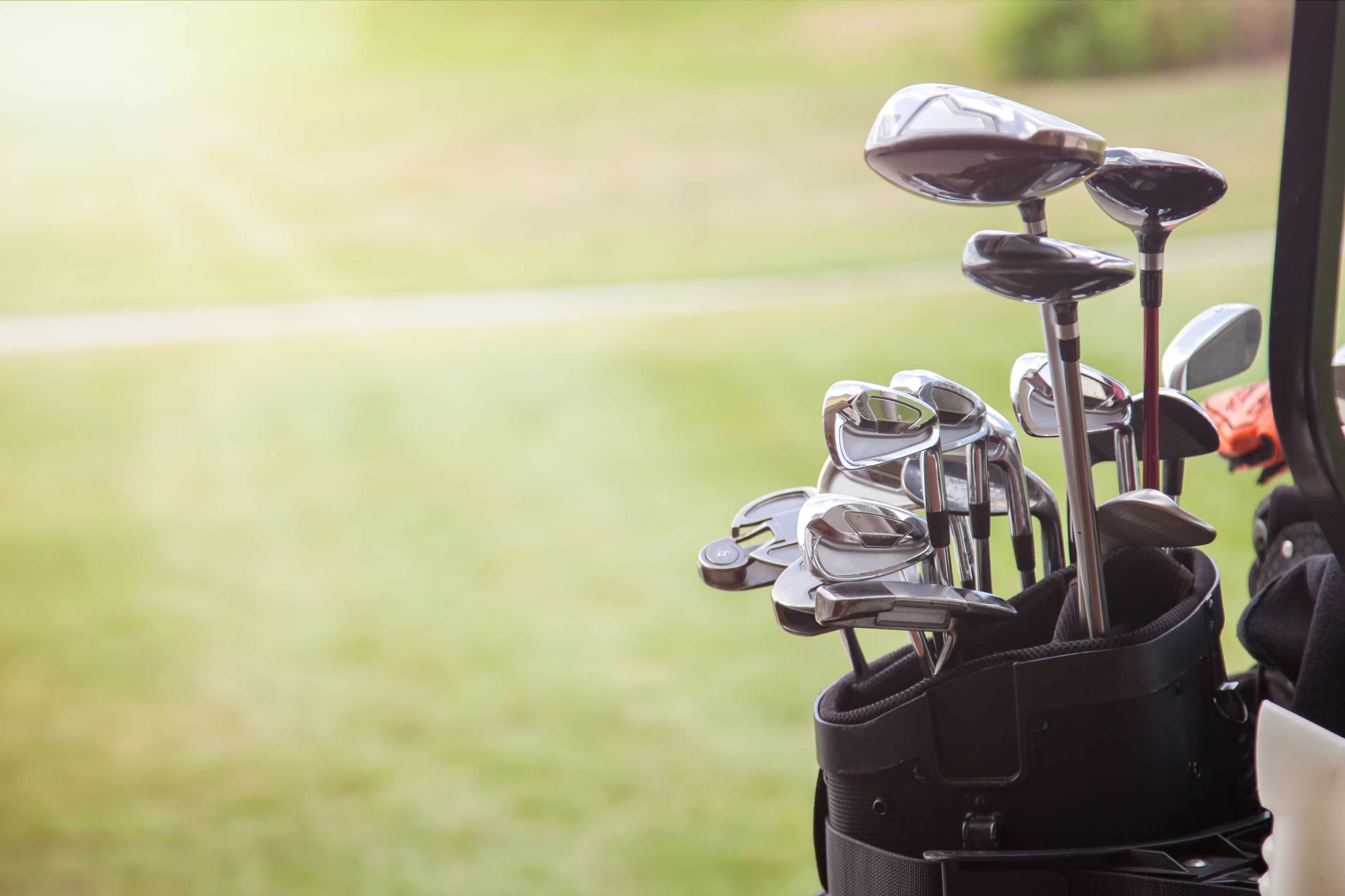 A golf bag with multiple clubs.