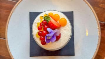 A dessert on a plate with a square napkin underneath.