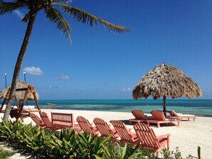 On the beach, white sand, sun-loungers, beach umbrellas
