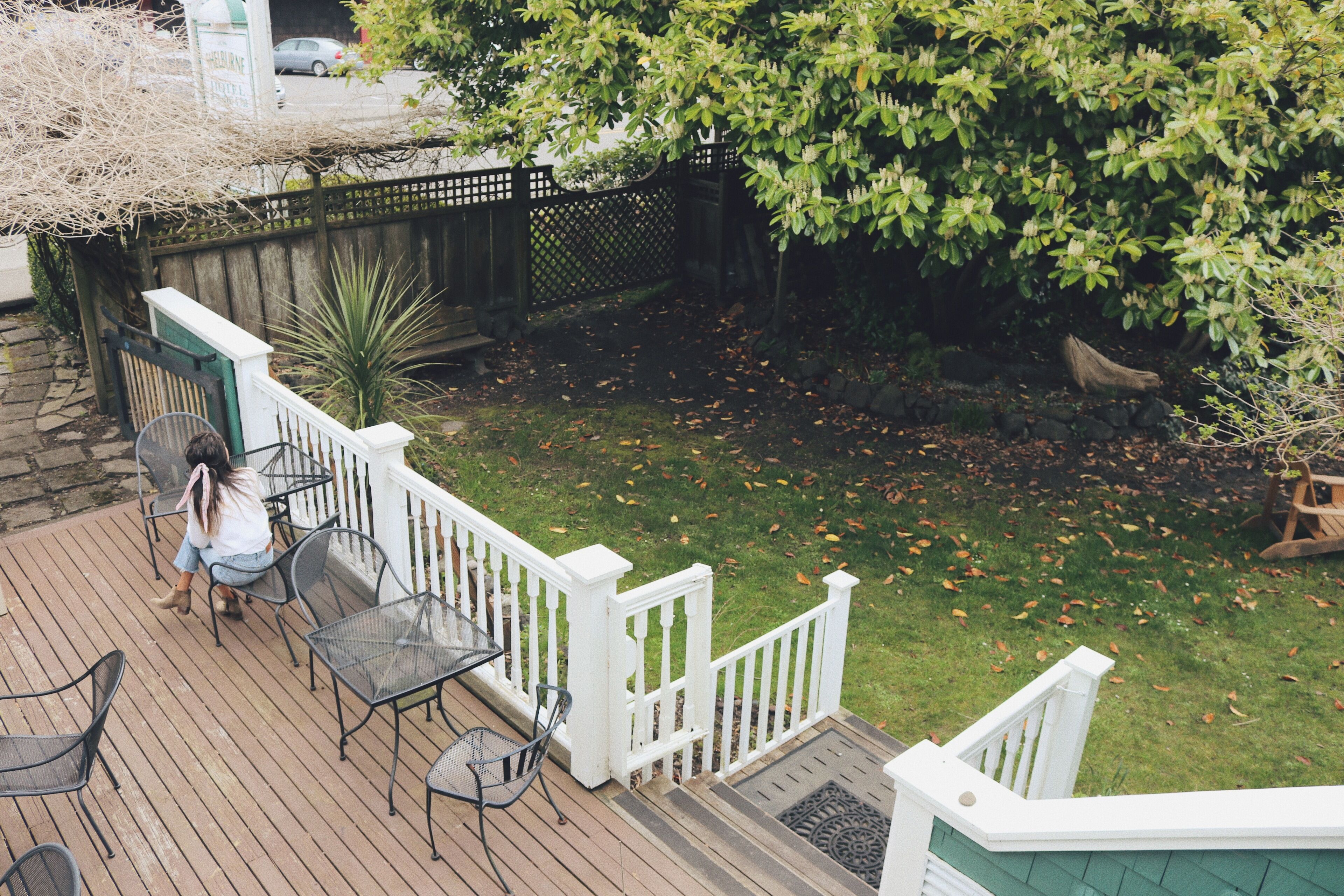 A wooden deck with outdoor furniture and a white railing.