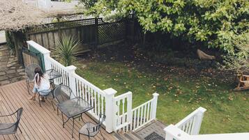 A wooden deck with outdoor furniture and a white railing.