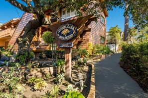 Un bâtiment portant une enseigne indiquant « Carmel Oaks Inn & Suites », et un chemin menant à l’entrée.
