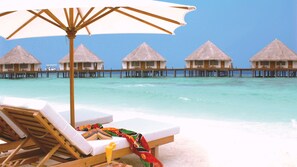 Private beach, white sand, sun loungers, beach umbrellas