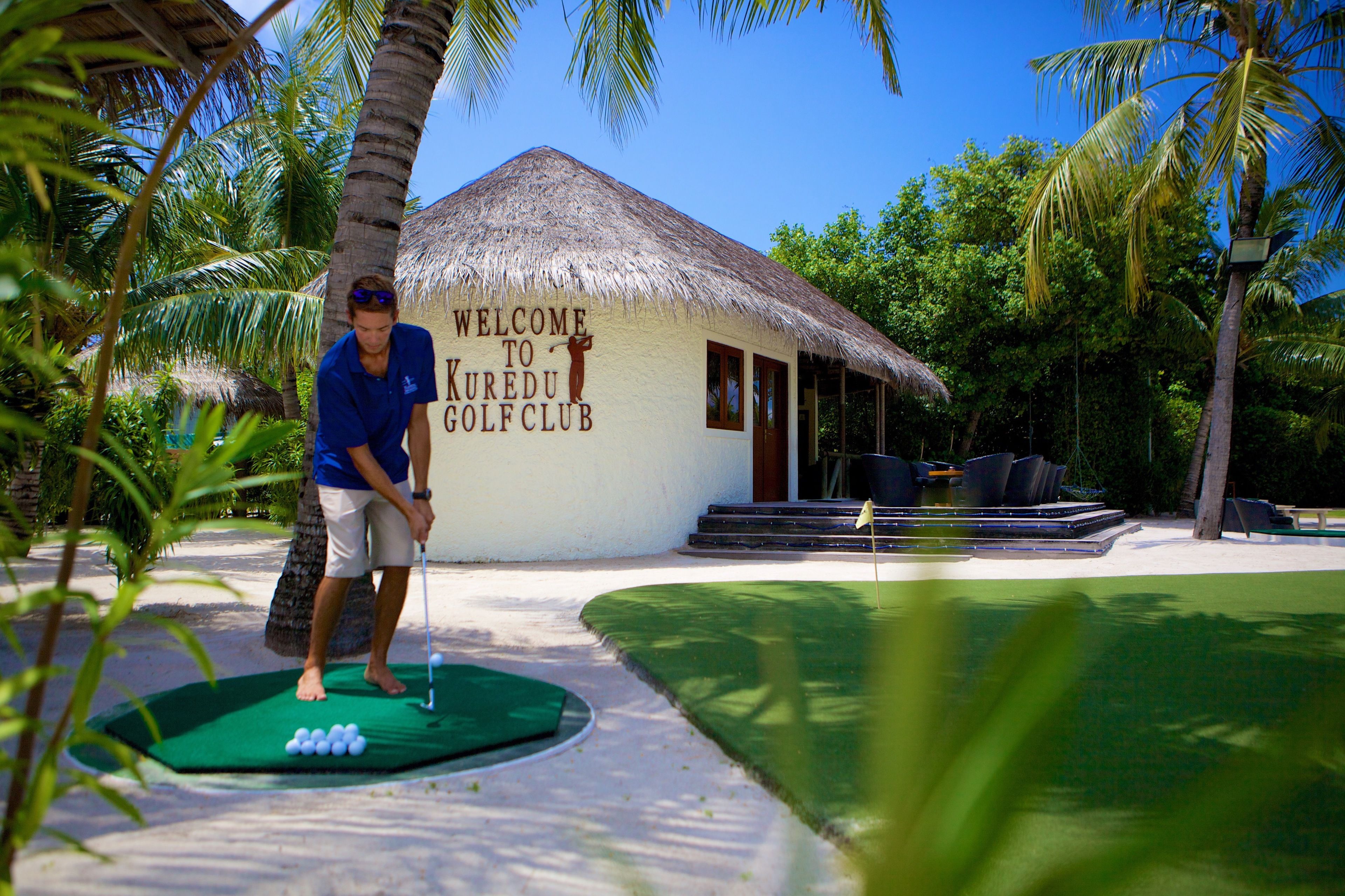 A golf course with a thatched-roof clubhouse labeled "Welcome to Kuredu Golf Club."