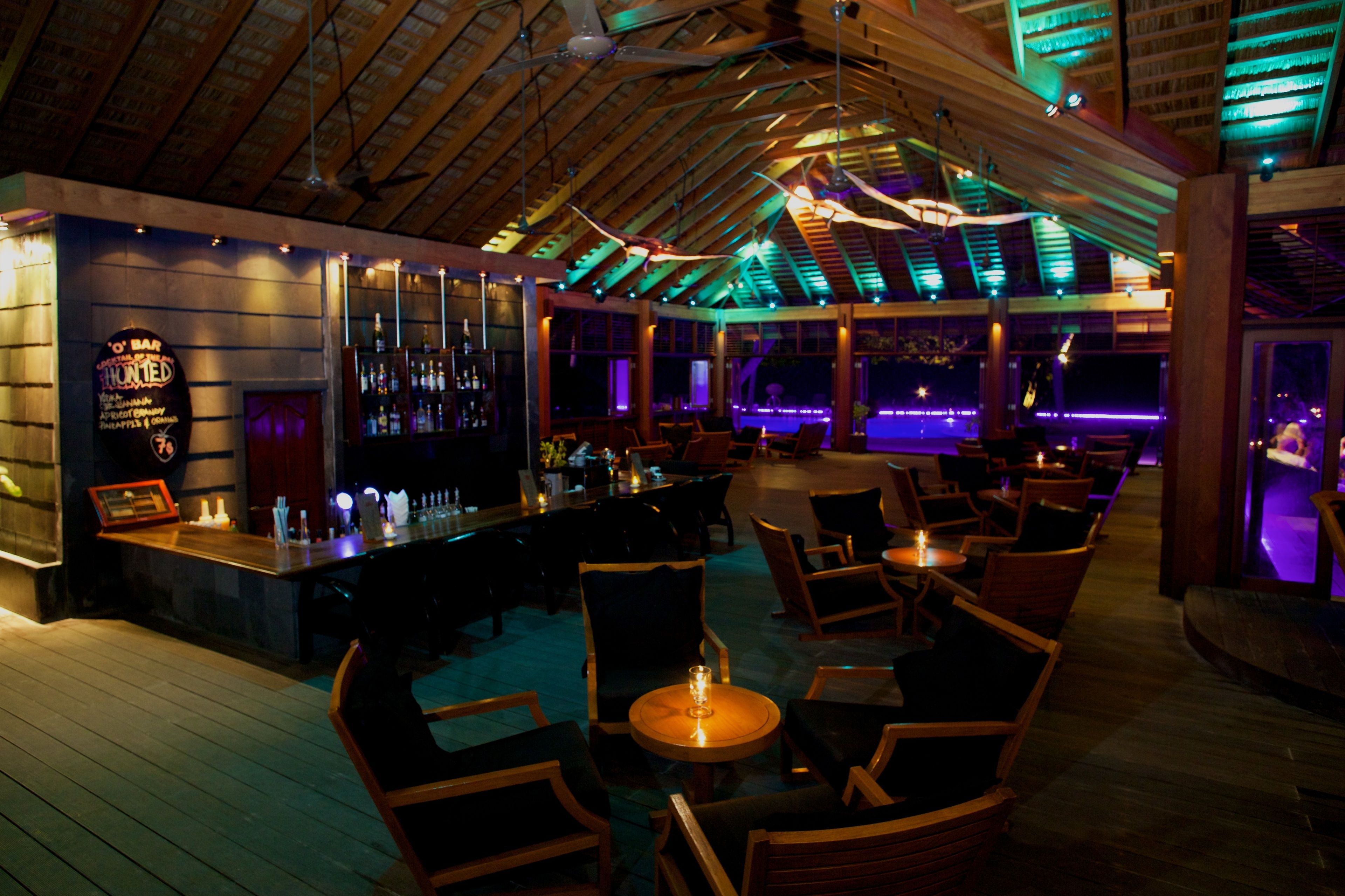 A bar area with wooden furniture and a bar counter.