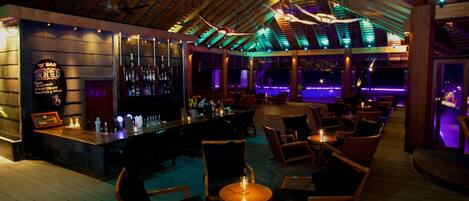 A bar area with wooden furniture and a bar counter.