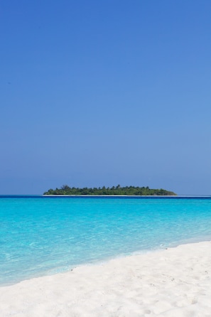 On the beach, white sand, beach towels, water skiing