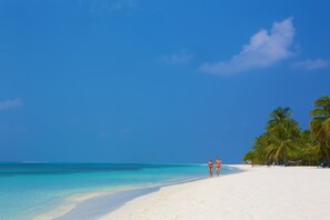 On the beach, white sand, beach towels, water skiing