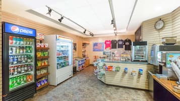 A convenience store with a Pepsi refrigerator, a refrigerated display, and a variety of snacks and beverages.