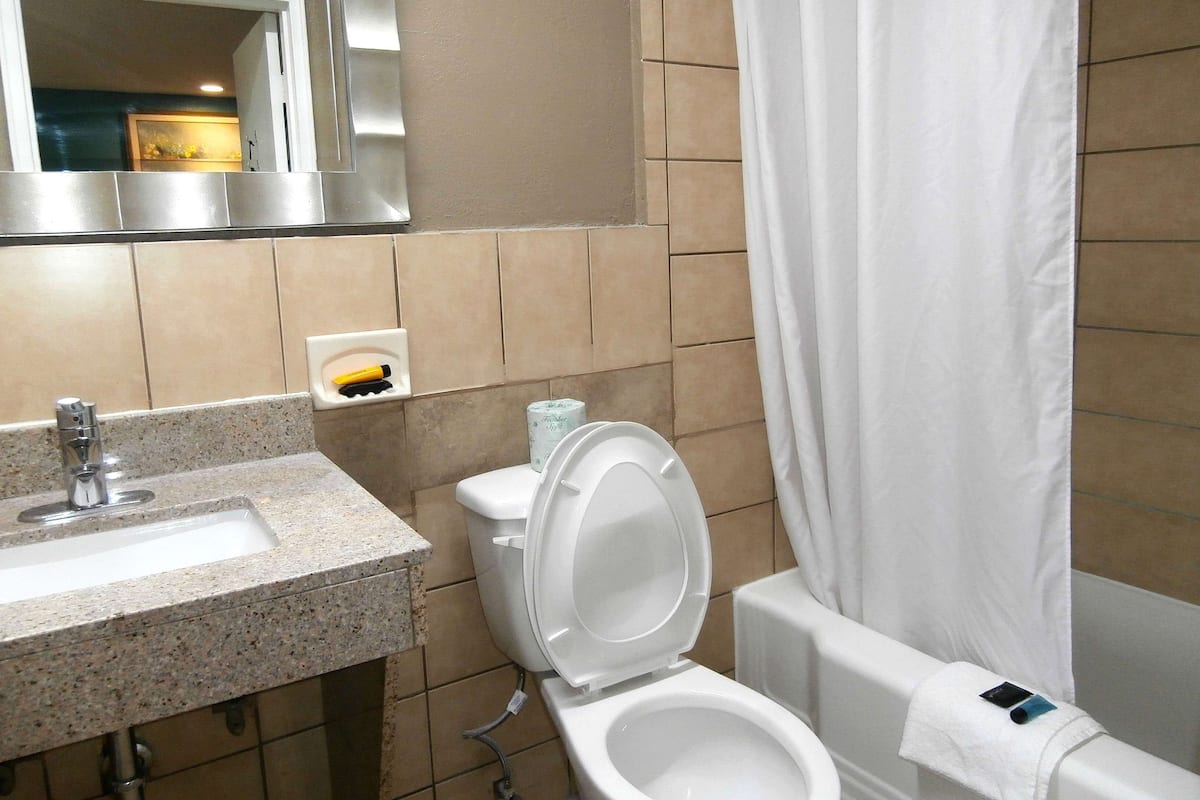 A bathroom with a sink, toilet, and bathtub.