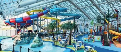 An indoor water park with slides, pools, and play areas.