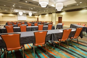 A conference room with multiple tables and chairs, carpeted floor, and ceiling lights. - Drury Inn & Suites Columbus Grove City (Grove City)
