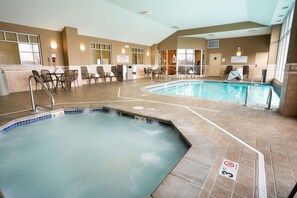 An indoor swimming pool with a hot tub, lounge chairs, and a seating area with tables. - Drury Inn & Suites Columbus Grove City (Grove City)