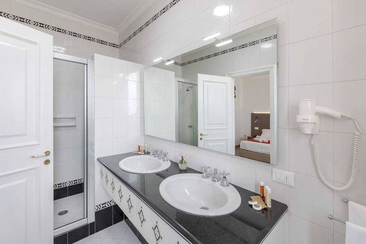 superior quadruple room | bathroom | shower, free toiletries, hair dryer, slippers