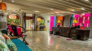 A spacious lobby with a patterned floor, a reception desk, and a seating area with a sofa and chairs. - Sino House Phuket Hotel (Phuket)