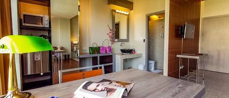 A modern bathroom with a vanity, mirror, and shower.