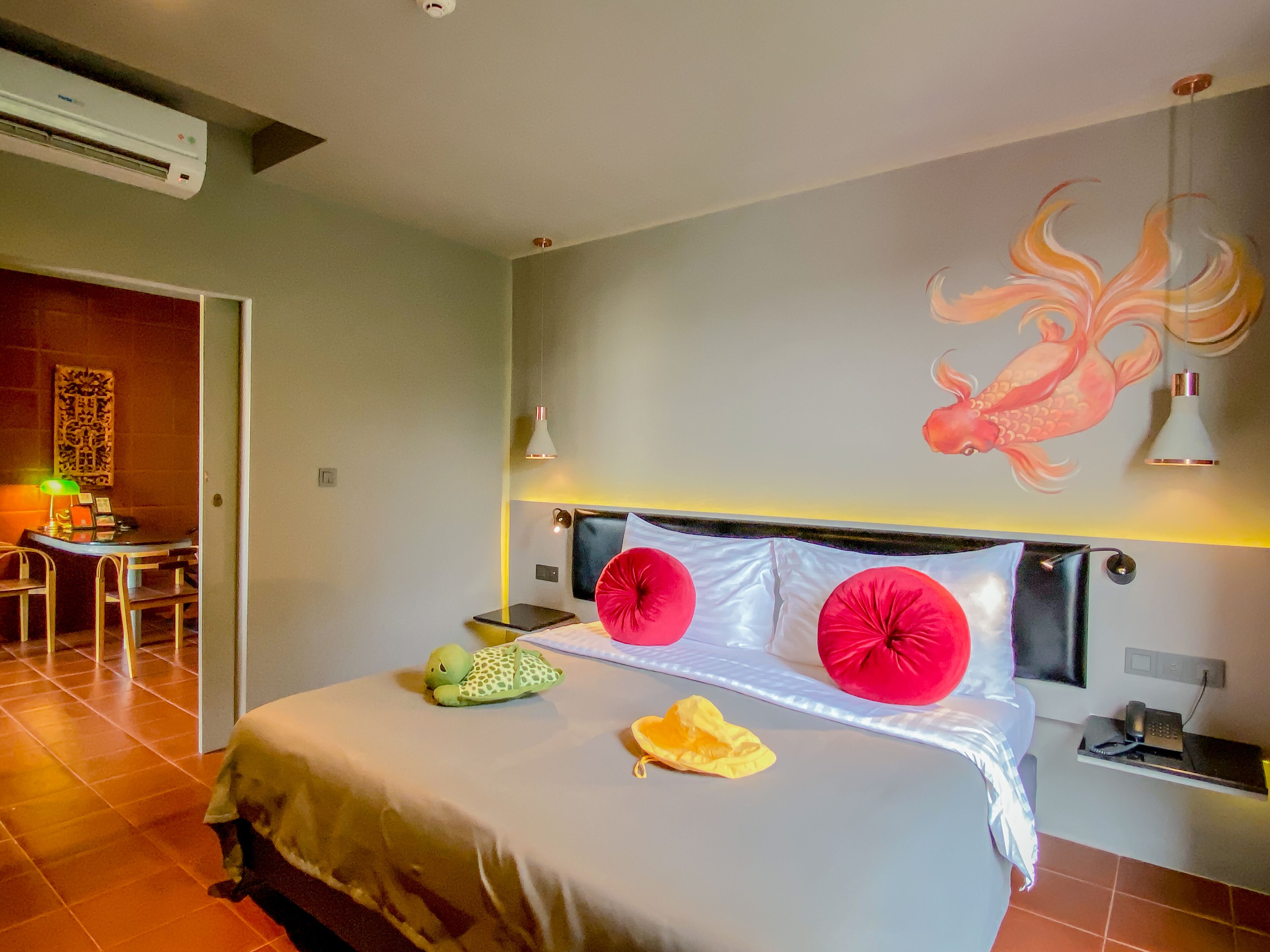 A hotel room with a bed, a desk, and a chair.