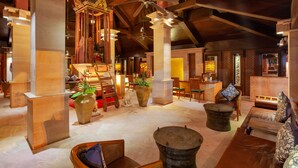 A spacious lobby with high ceilings, wooden beams, and a central seating area with sofas and chairs. - Seaview Patong Hotel (Patong)