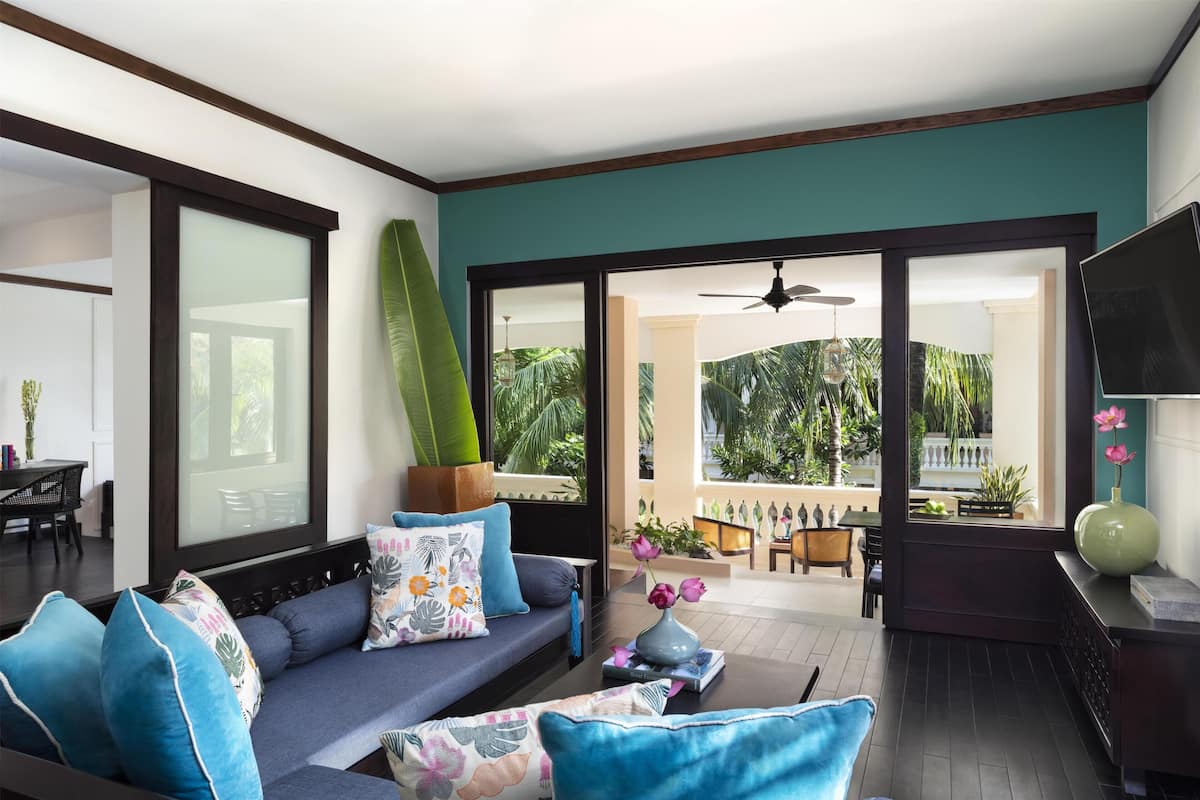 A modern living room with a sofa, coffee table, and a view of the outdoor patio.