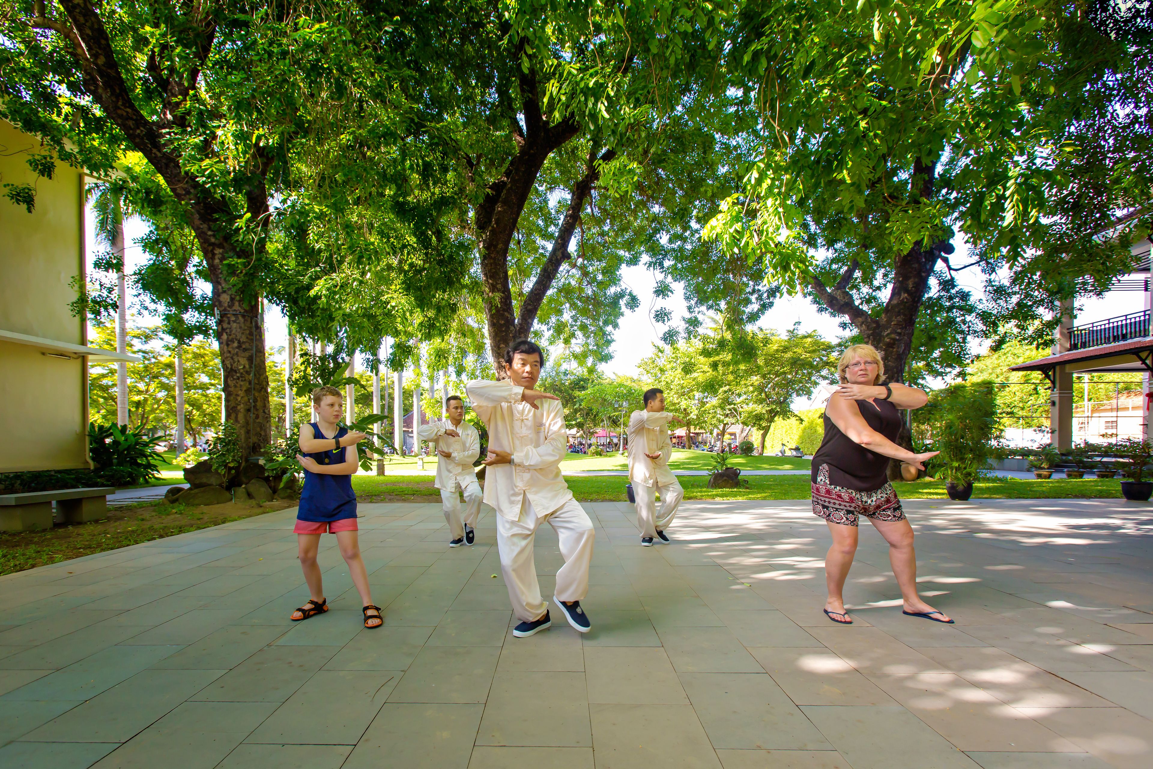 A group of people performing a dance routine outdoors.