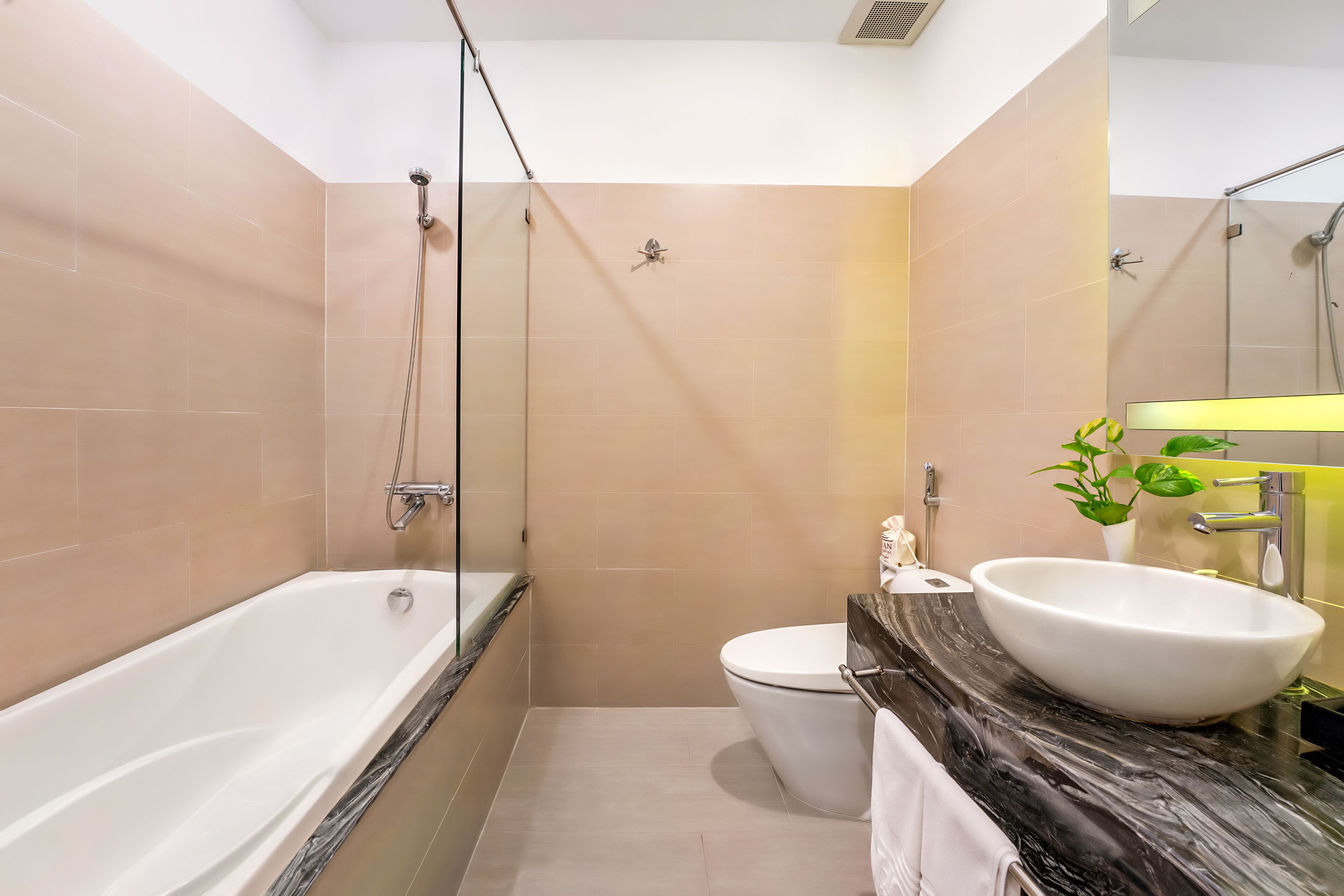 A modern bathroom with a bathtub, toilet, and sink.