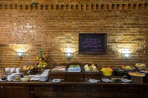 A buffet with various food items and a chalkboard with motivational writing.