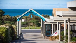 A coastal building with a blue roof and a view of the sea.
