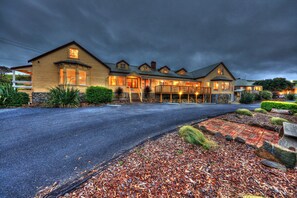 A large, multi-story hotel with a covered outdoor area and a driveway leading to the entrance. - Stanley Seaview Inn (Stanley)