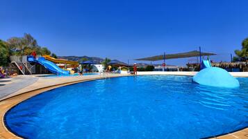 Enjoy a refreshing swim in our pool surrounded by a deck and water slides.