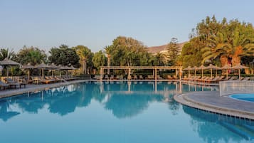 Seasonal outdoor pool, open 9:00 AM to 6:00 PM, pool umbrellas