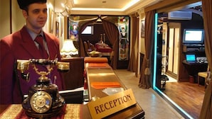 A reception area with a vintage telephone, a reception desk, and a sign that reads "RECEPTION". - Boutique Palace Hotel Baku (Baku)