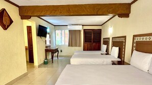 A hotel room with two beds, a television, a window with curtains, and a door leading to another room. - Suites Cancun Center Cancun (Cancun)