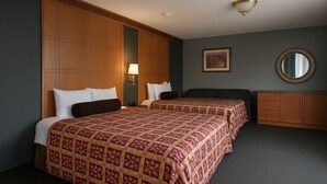 A hotel room with two beds, a dresser, a mirror, and a painting on the wall. - Liberty Inn Atlantic City (Absecon)