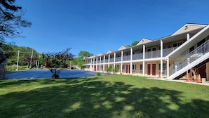 A multi-story hotel with a central courtyard, balconies, and a covered walkway.