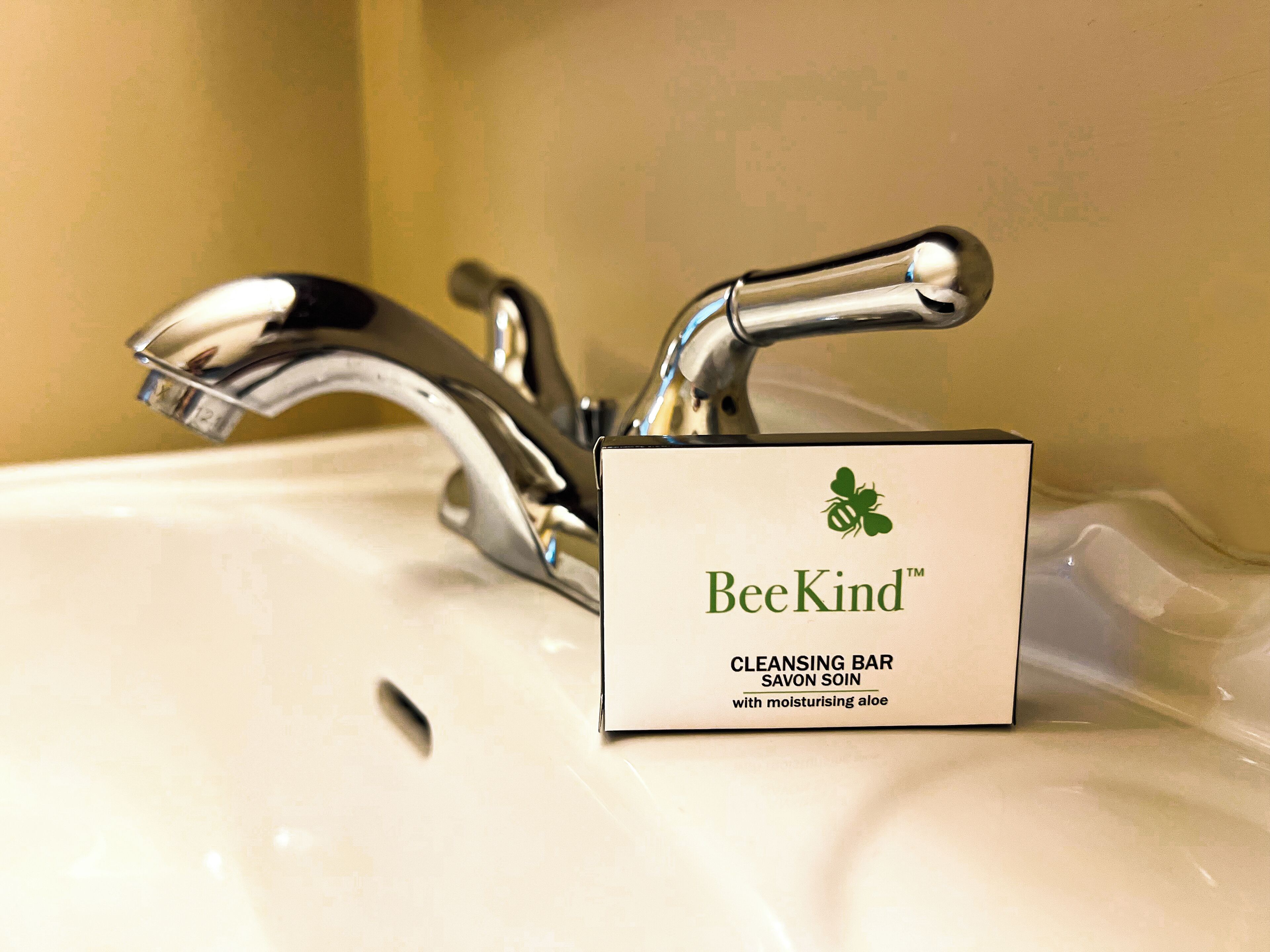 A bathroom sink with a BeeKind cleansing bar soap.