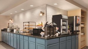 A modern kitchen with a central island, equipped with a coffee machine, a microwave, and a refrigerator. - Country Inn & Suites by Radisson, Boone, NC (Boone)