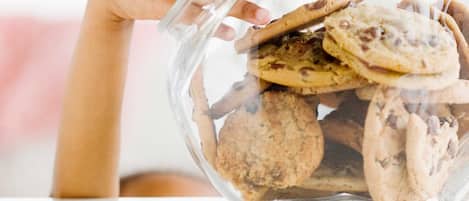 A clear glass container filled with cookies.