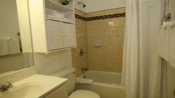 A bathroom with a toilet, sink, and bathtub.