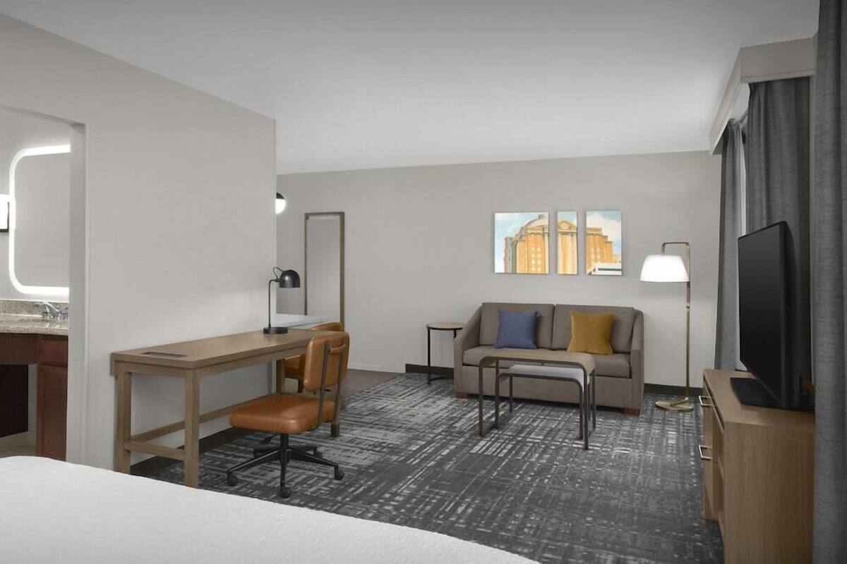 Premium bedding, desk, laptop workspace, blackout drapes