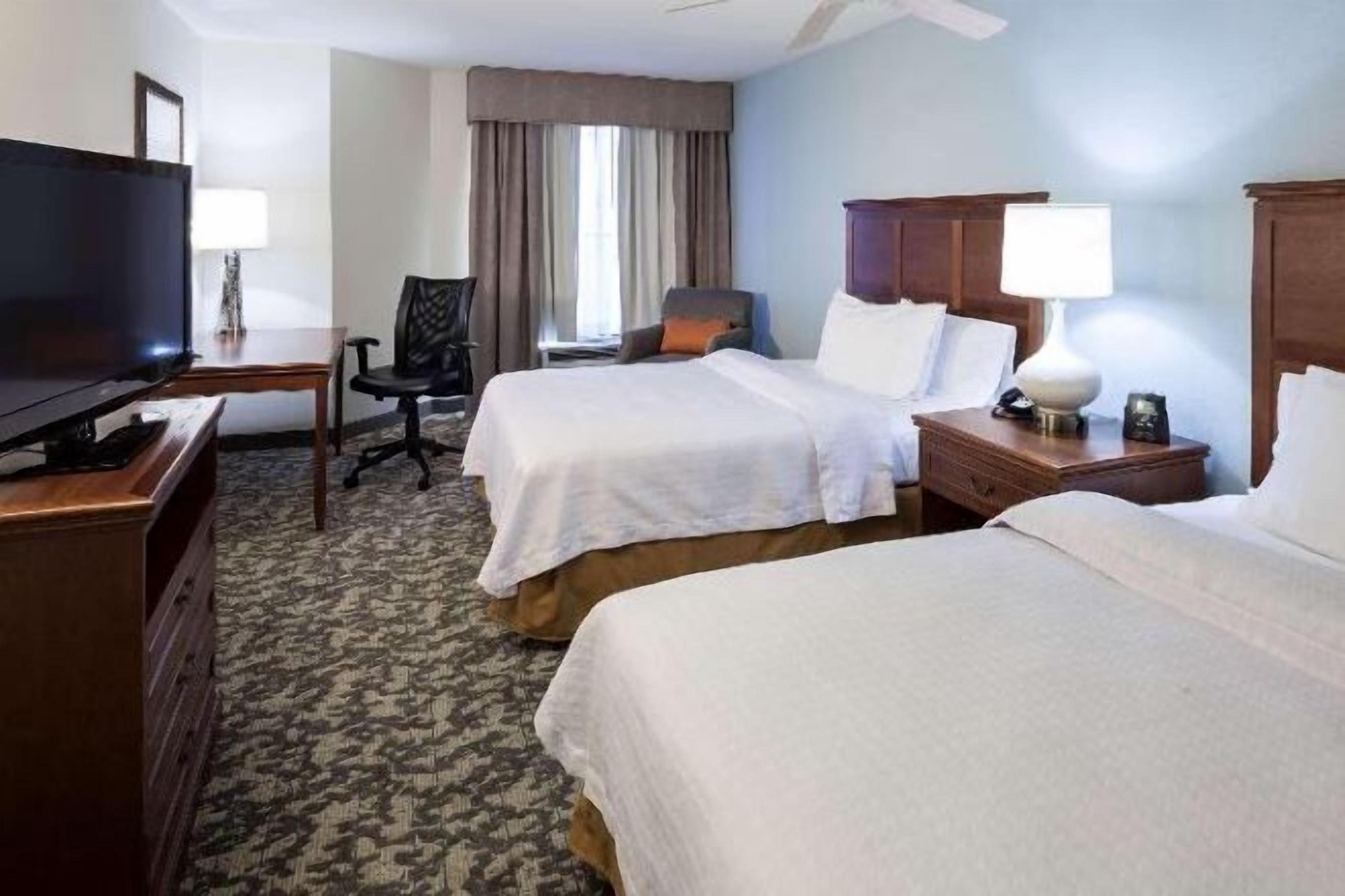 Premium bedding, desk, laptop workspace, blackout drapes