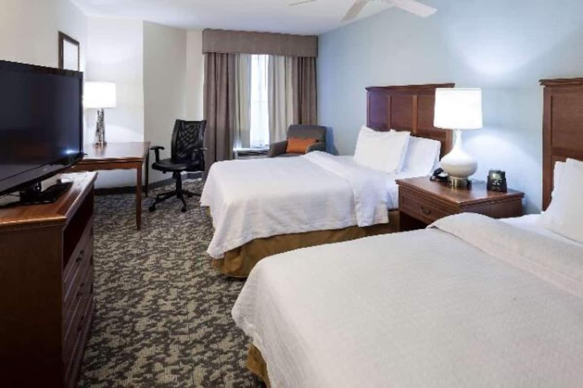 Premium bedding, desk, laptop workspace, blackout drapes