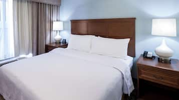 Premium bedding, desk, laptop workspace, blackout drapes