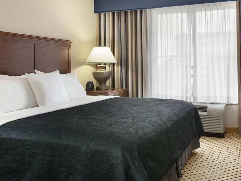 Premium bedding, desk, laptop workspace, blackout drapes
