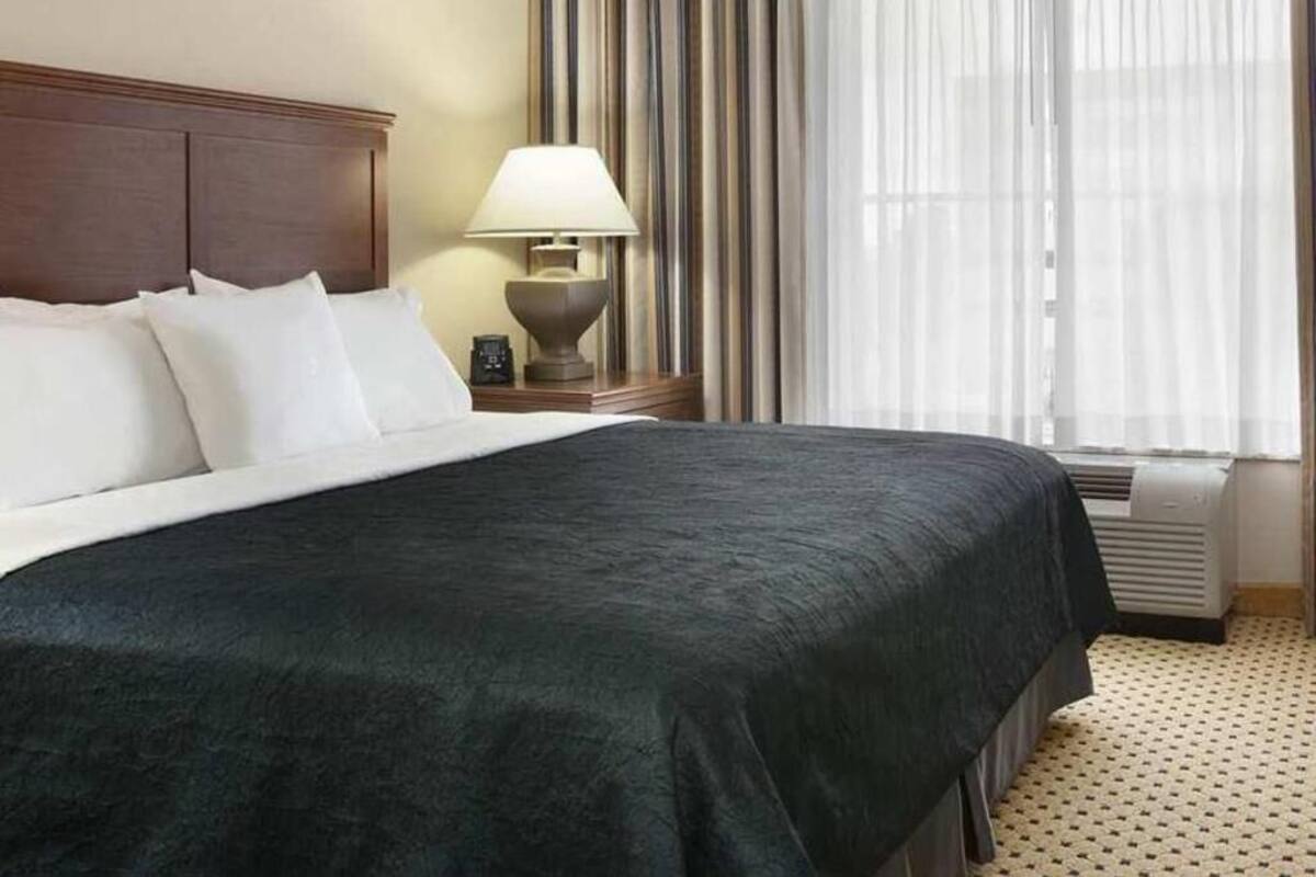 Premium bedding, desk, laptop workspace, blackout drapes