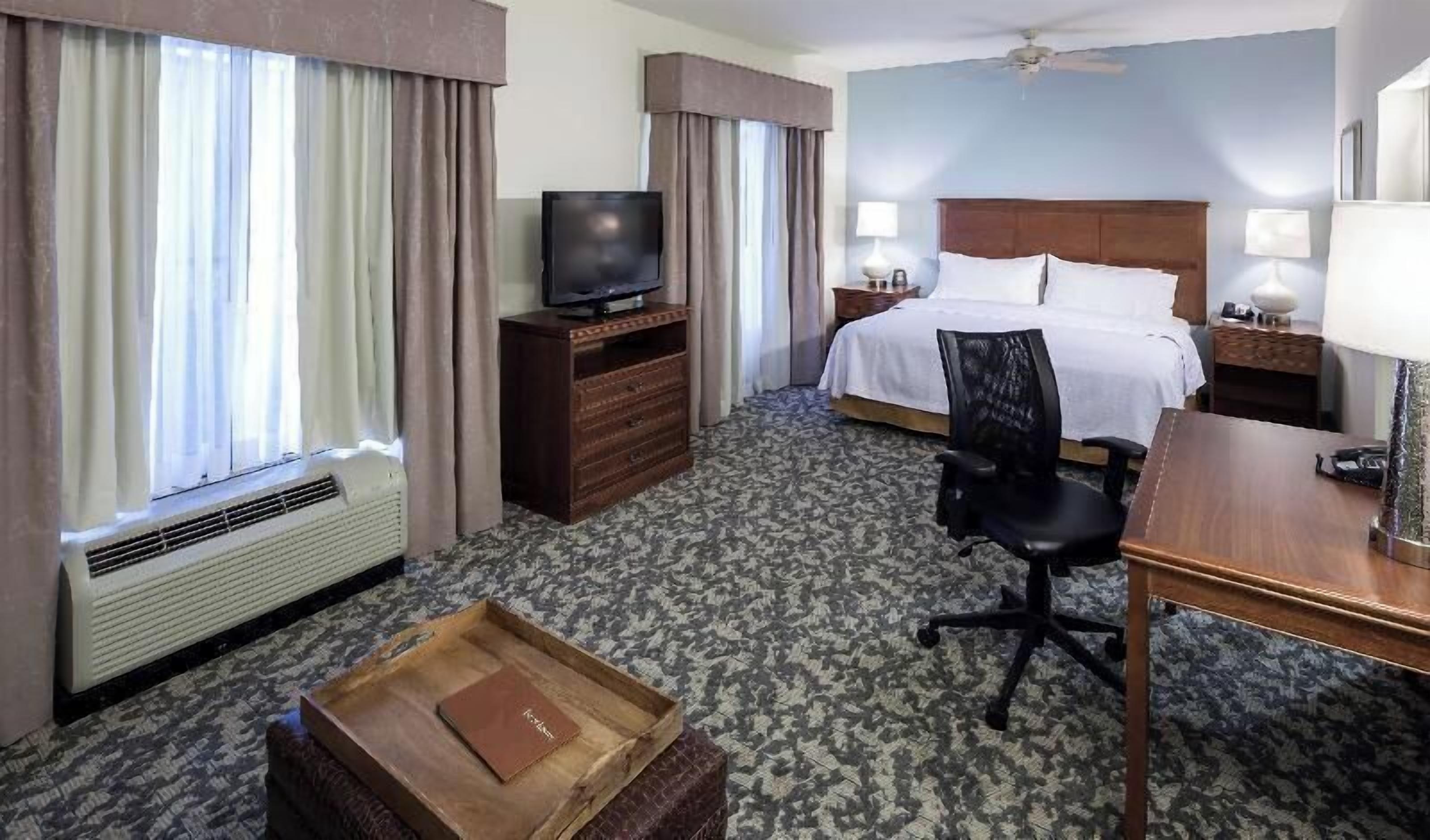 Premium bedding, desk, laptop workspace, blackout drapes