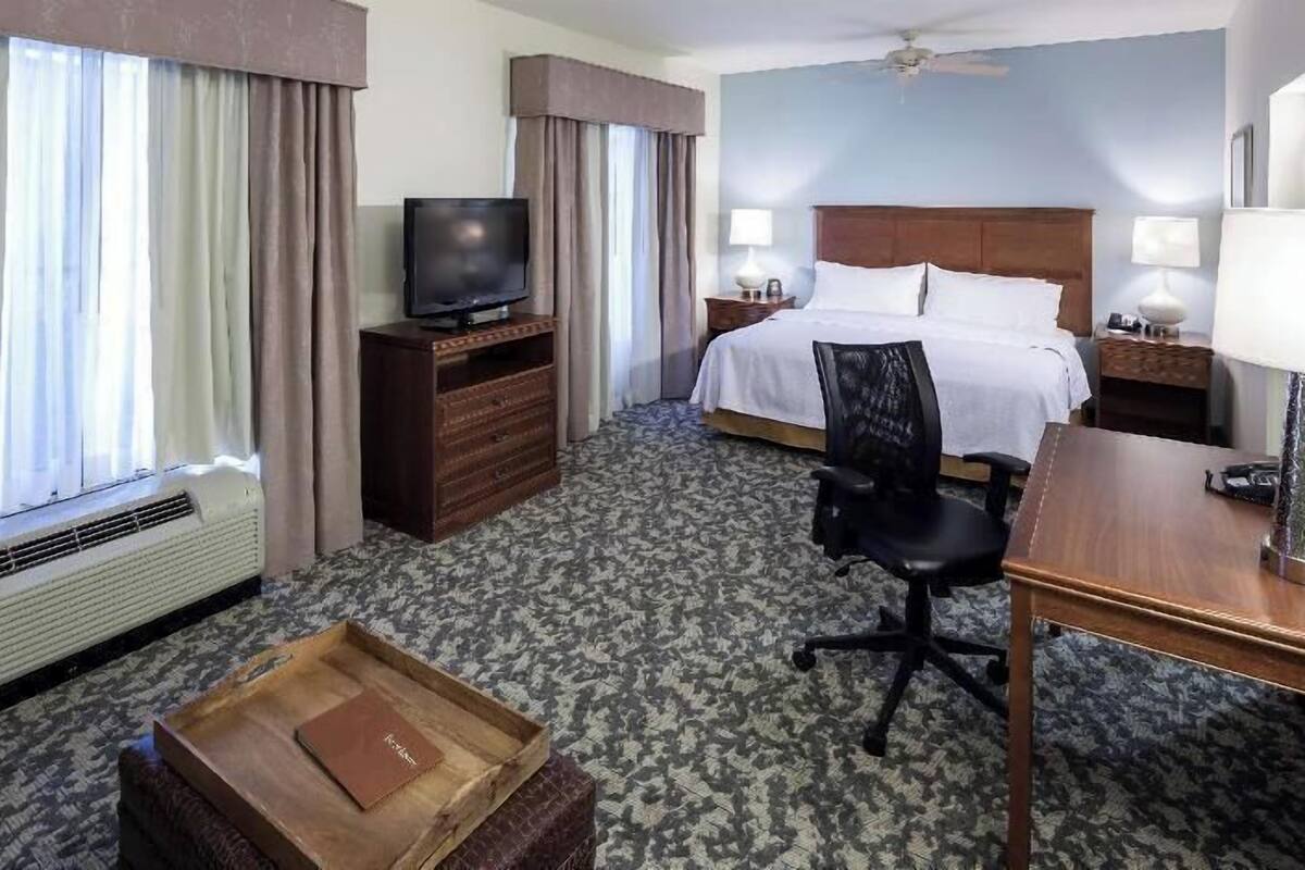 Premium bedding, desk, laptop workspace, blackout drapes