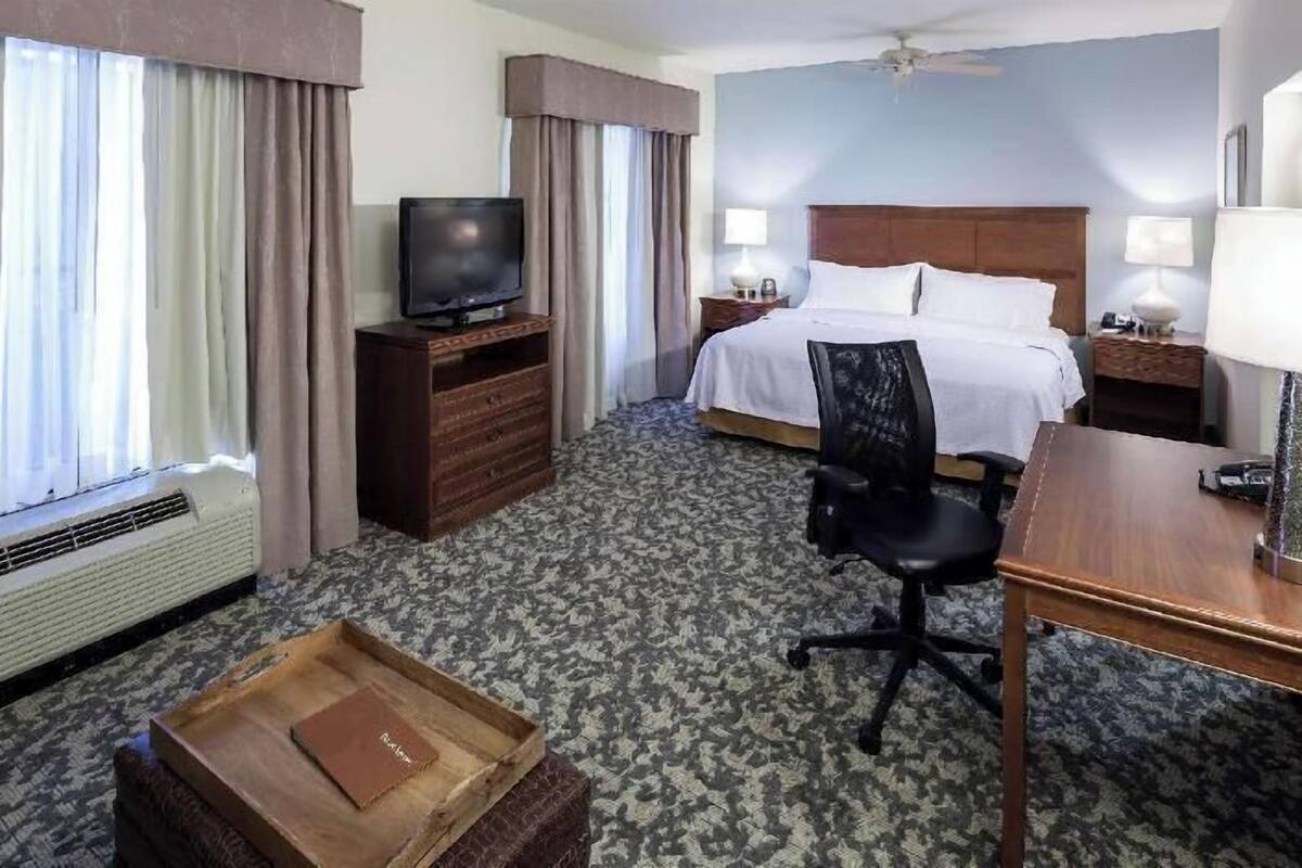Premium bedding, desk, laptop workspace, blackout drapes