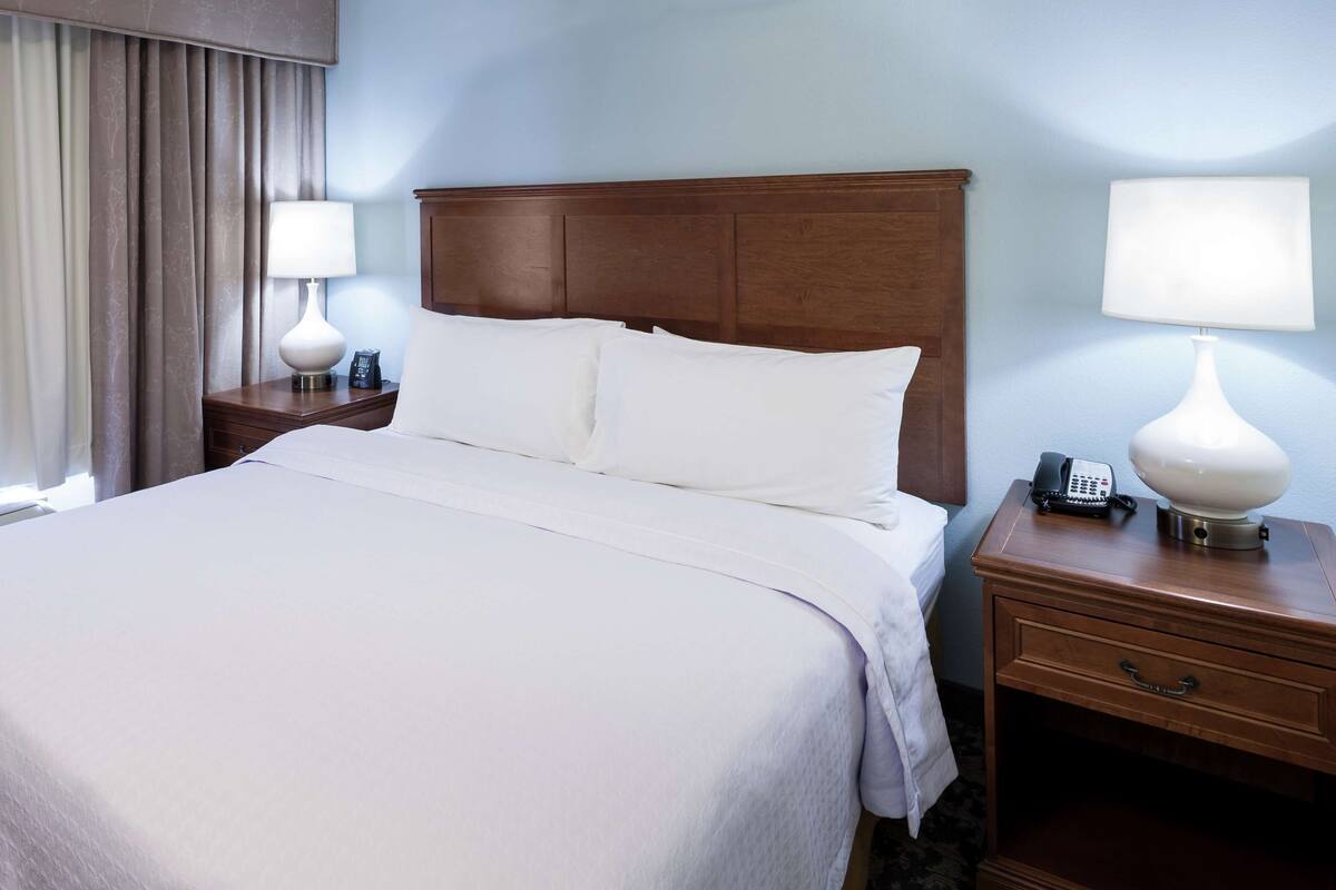 Premium bedding, desk, laptop workspace, blackout drapes